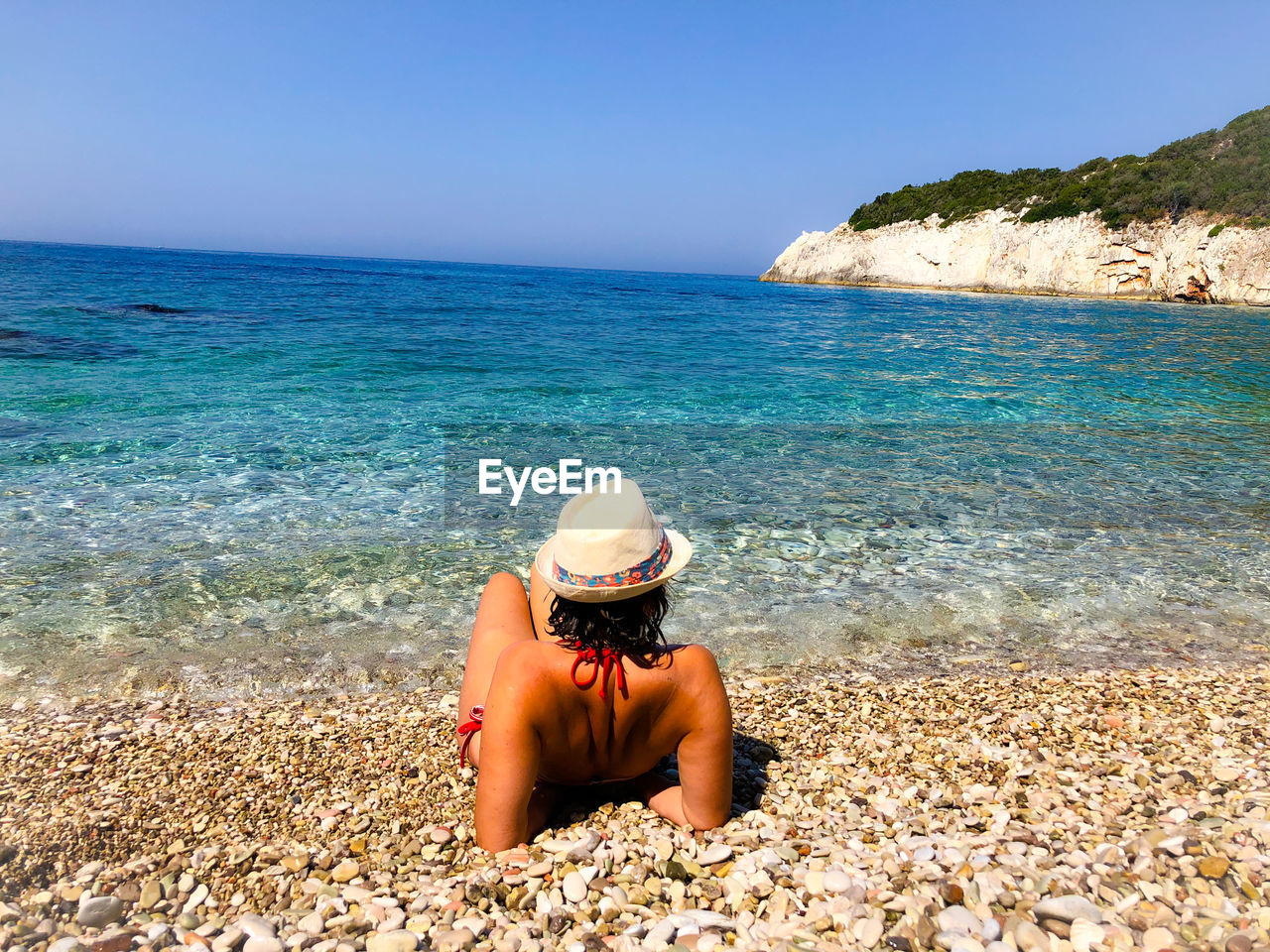 Woman with bikini sitting close to the beach.ionian sea albania