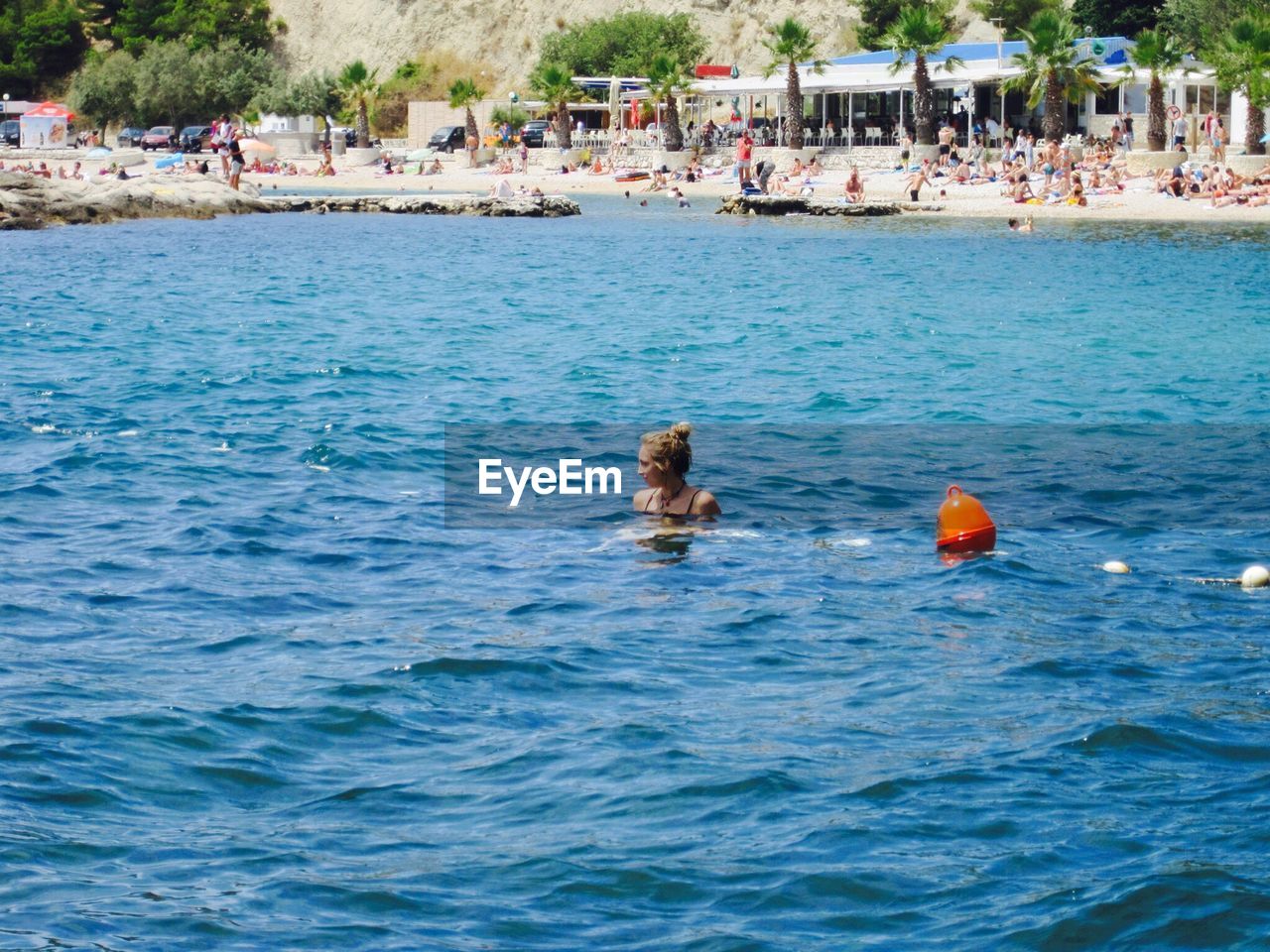 High angle view of woman swimming in sea