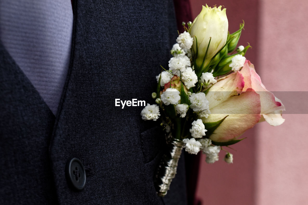 Close-up of boutonniere on bridegroom suit
