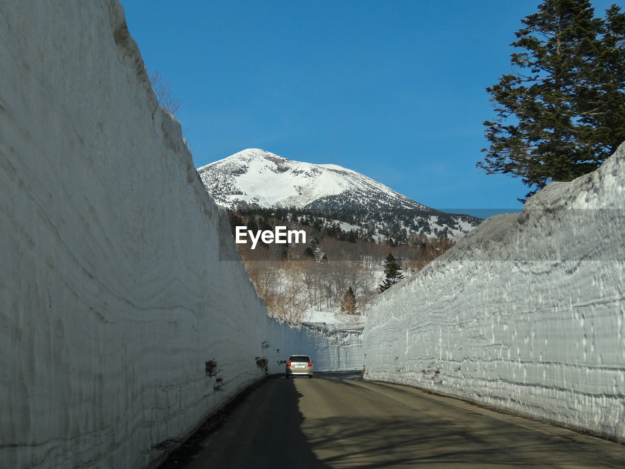 ROAD AMIDST SNOWCAPPED MOUNTAIN AGAINST SKY