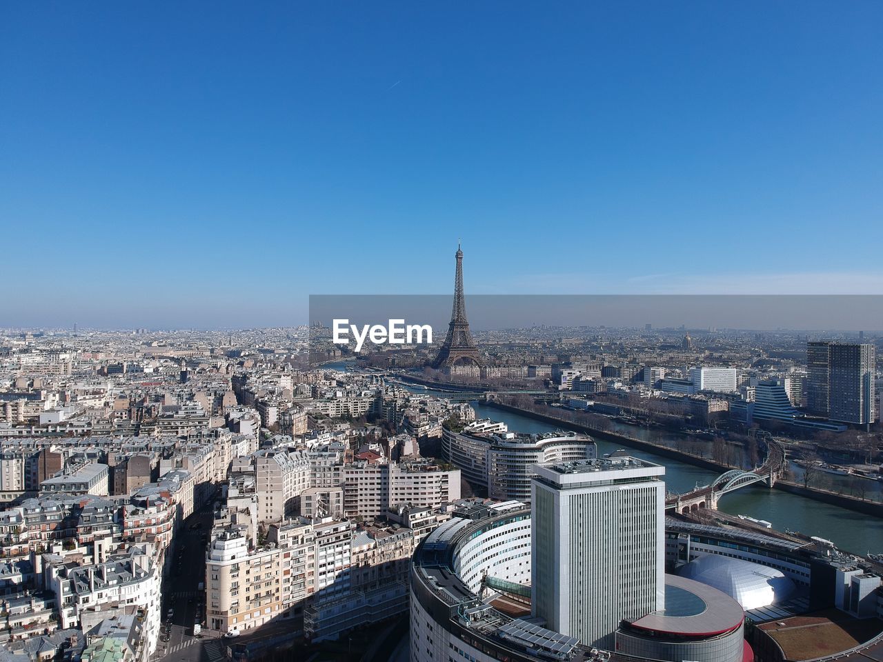 Aerial view of city buildings against clear blue sky paris eiffel tower drone