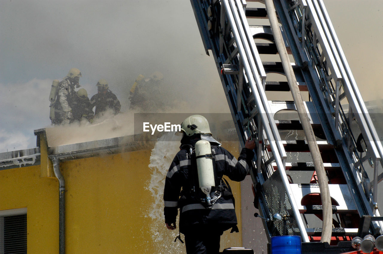 Fire department emergency response to a fire with a turntable ladder