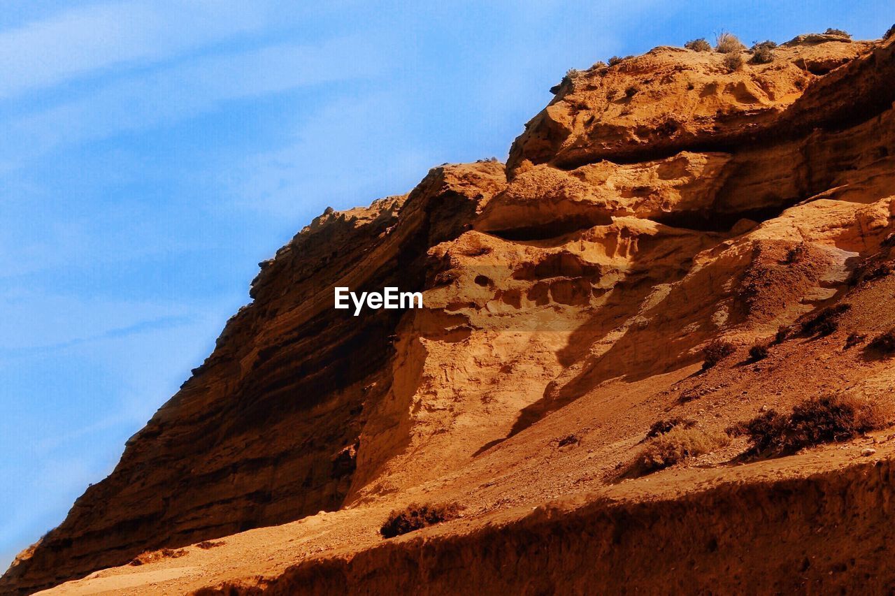 Low angle view of rock formation against sky