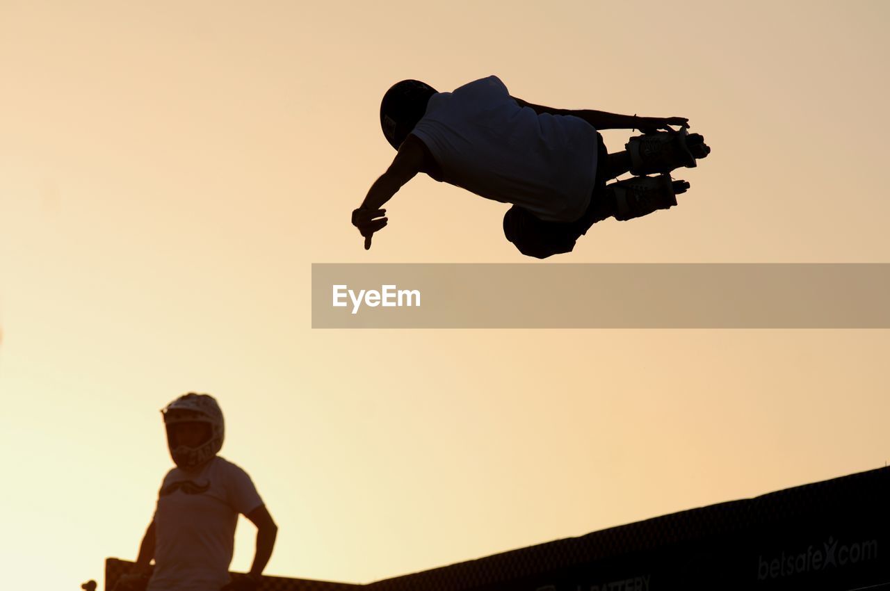 Man roller skating during sunset