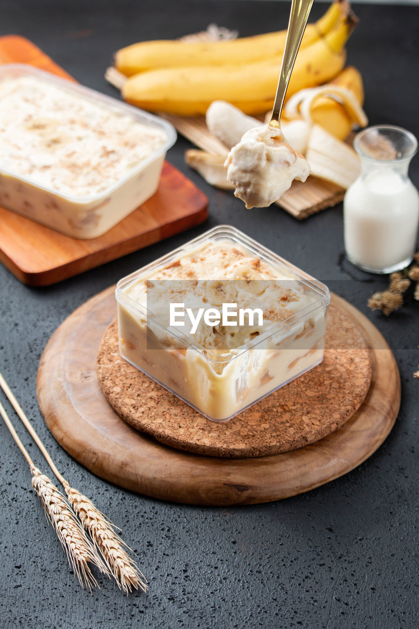 
a high angle view photo of homemade banana dessert box served on table,