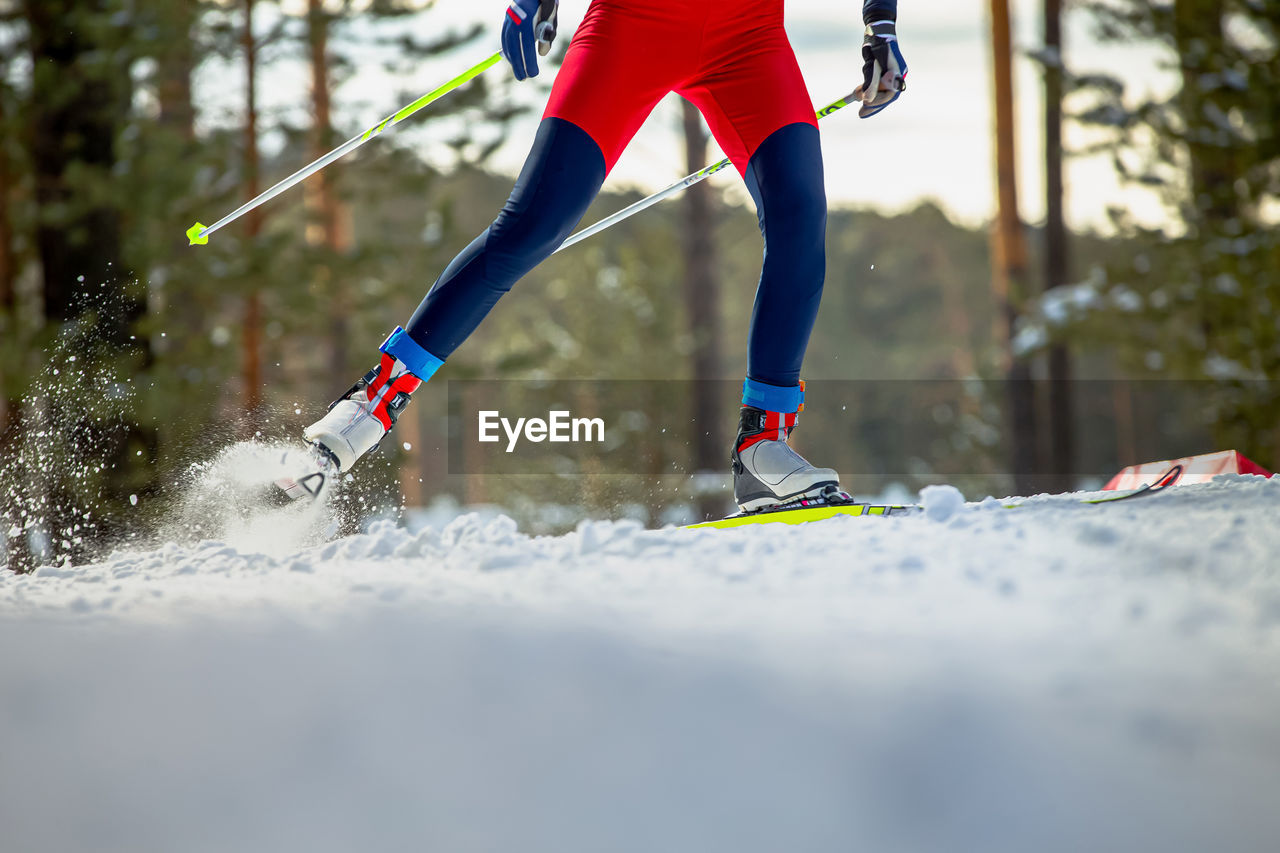 Male skier athlete goes uphill on cross-country skiing