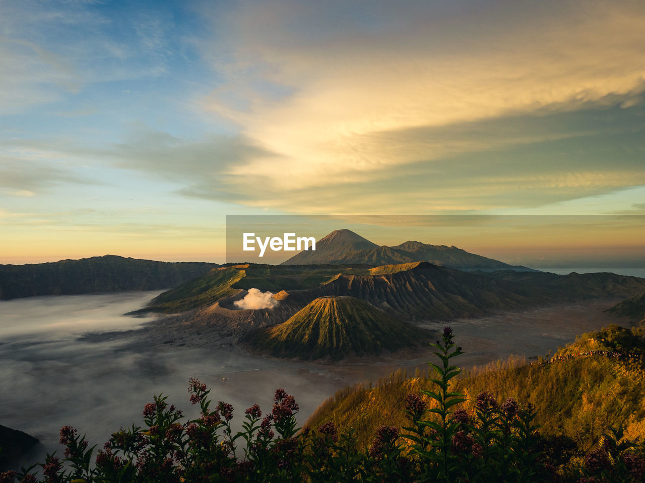 Scenic view of vulcanic landscape against cloudy sky during sunrise