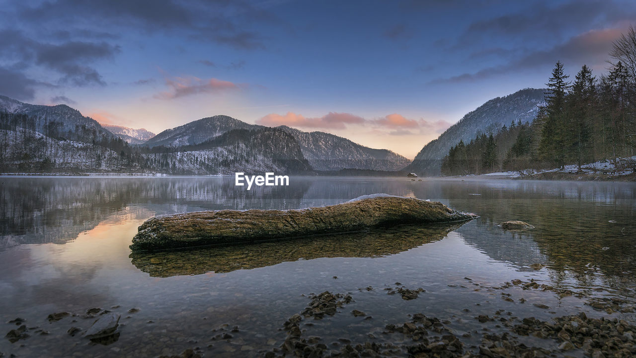 Scenic view of lake and mountains against sky