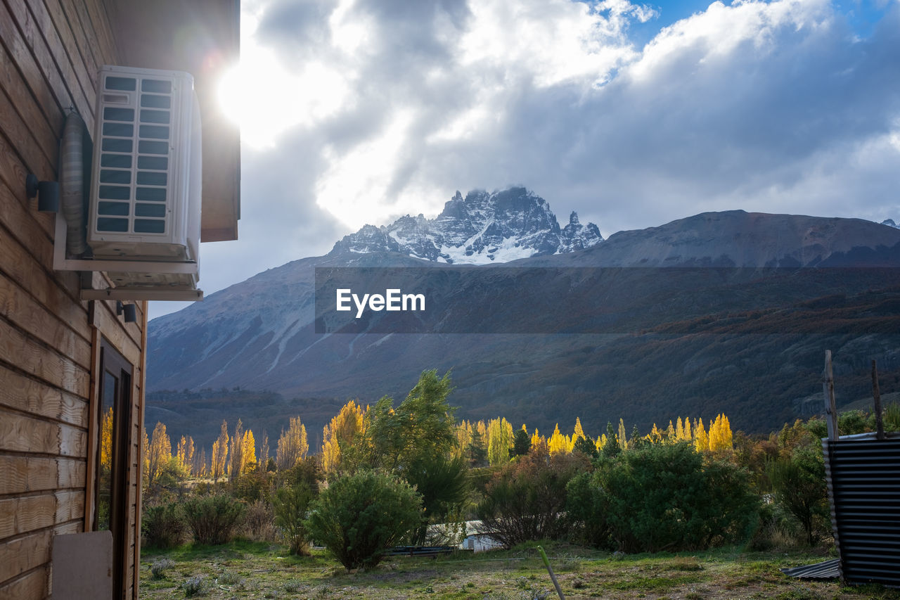 low angle view of trees and mountains against sky