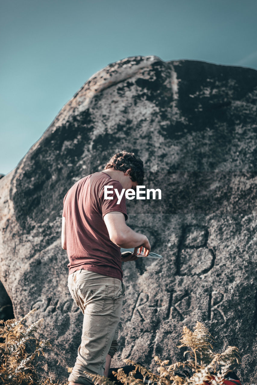 LOW SECTION OF MAN ON ROCK