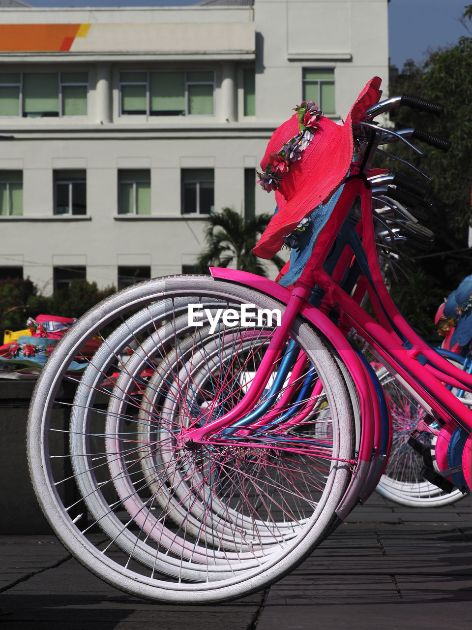 BICYCLE PARKED ON STREET AGAINST BUILDING