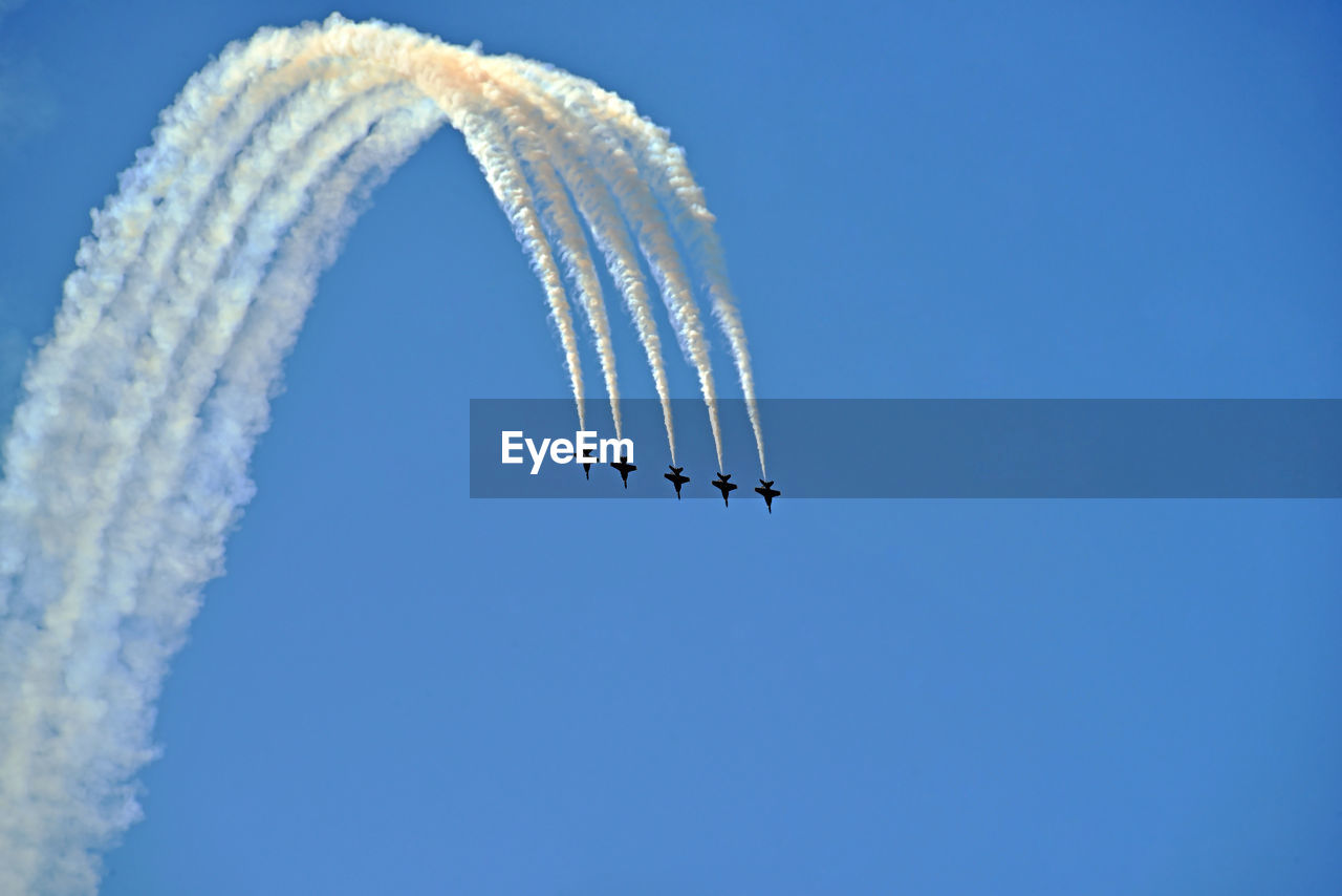 LOW ANGLE VIEW OF VAPOR TRAIL AGAINST BLUE SKY