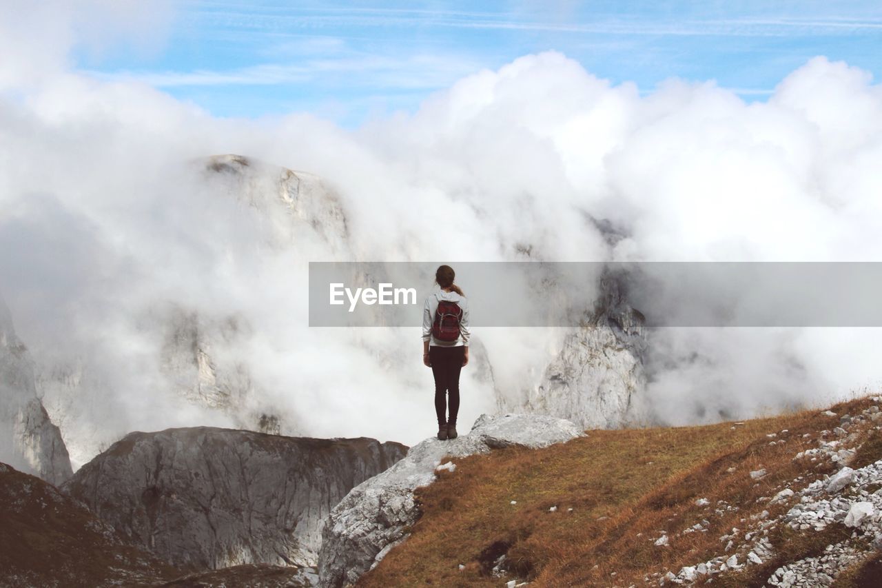 Rear view of woman standing on mountain