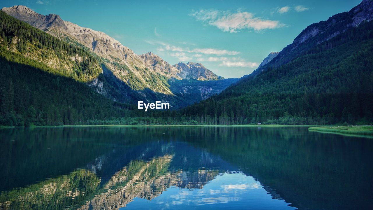 Scenic view of lake and mountains against sky