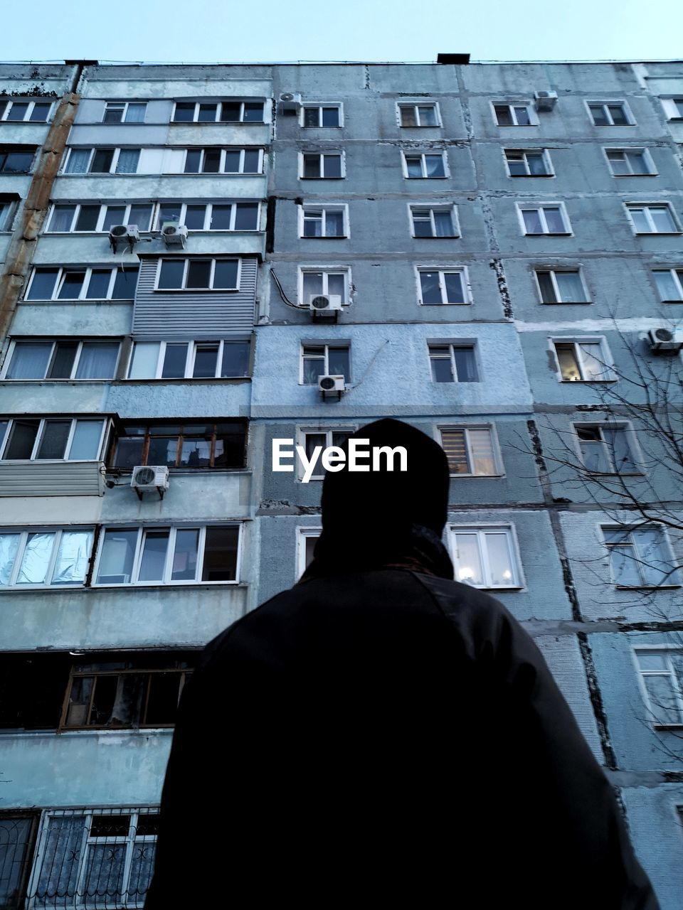 Rear view of man looking at building in city