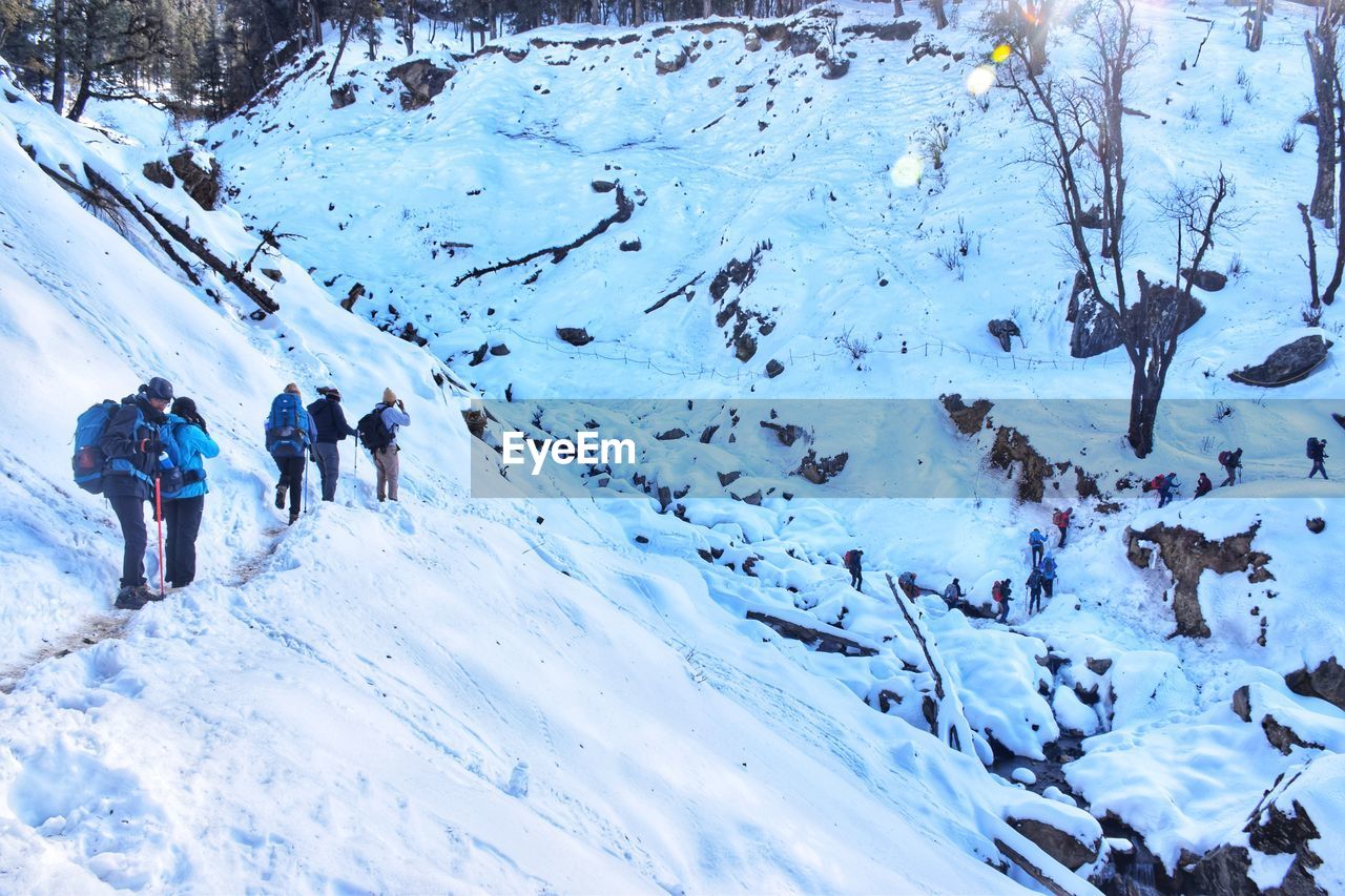 People walking on snow covered mountain