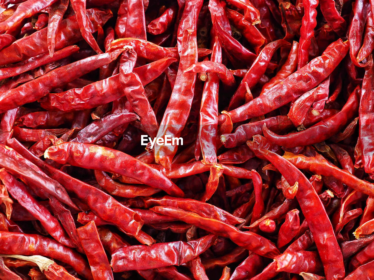 FULL FRAME SHOT OF RED CHILI PEPPERS AT MARKET