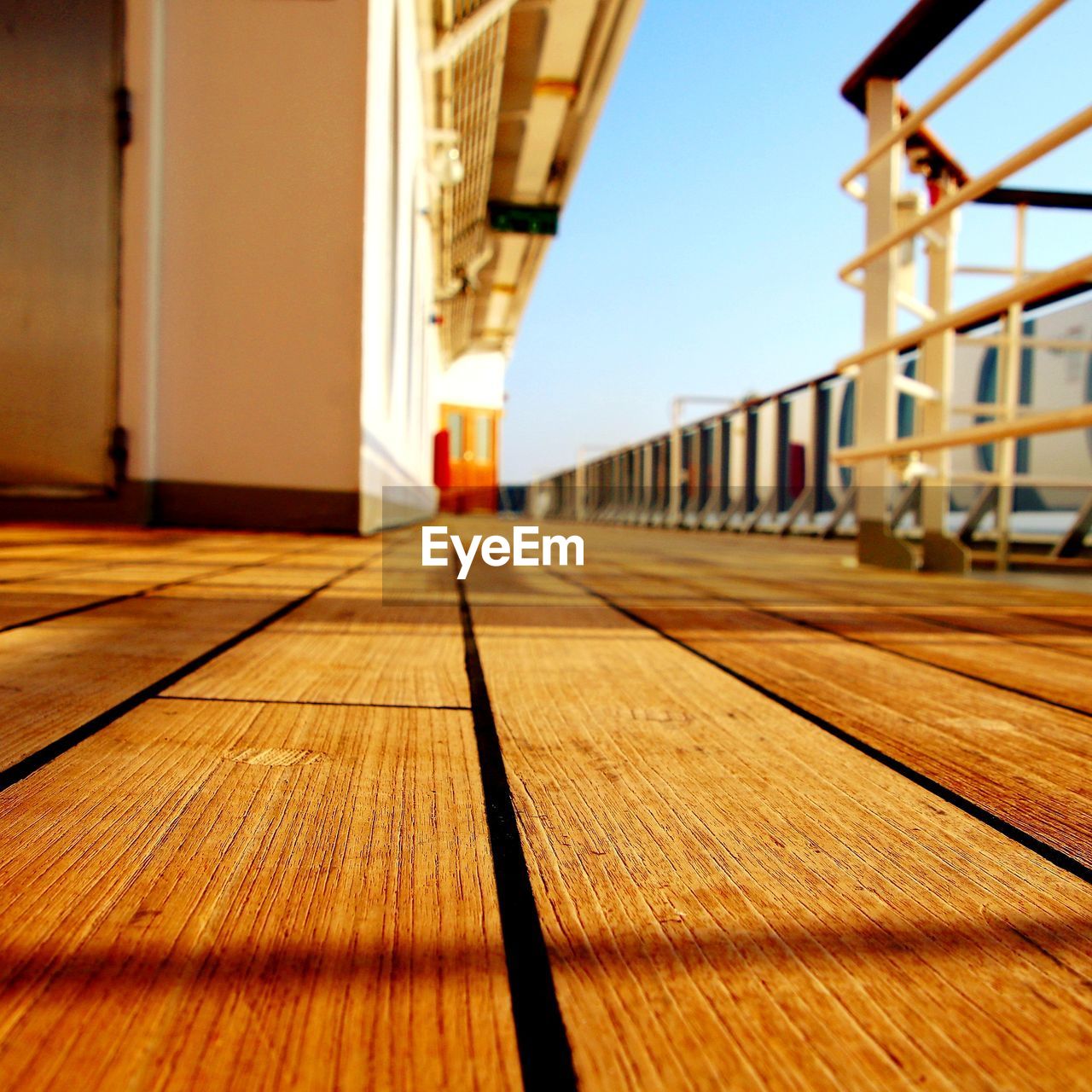 SURFACE LEVEL OF WOODEN WALKWAY AGAINST BUILDINGS