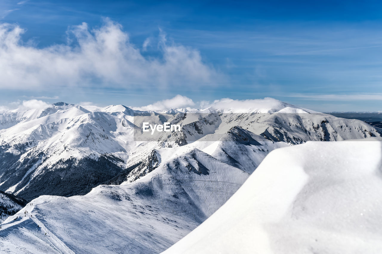 SCENIC VIEW OF SNOWCAPPED MOUNTAINS AGAINST SKY DURING WINTER