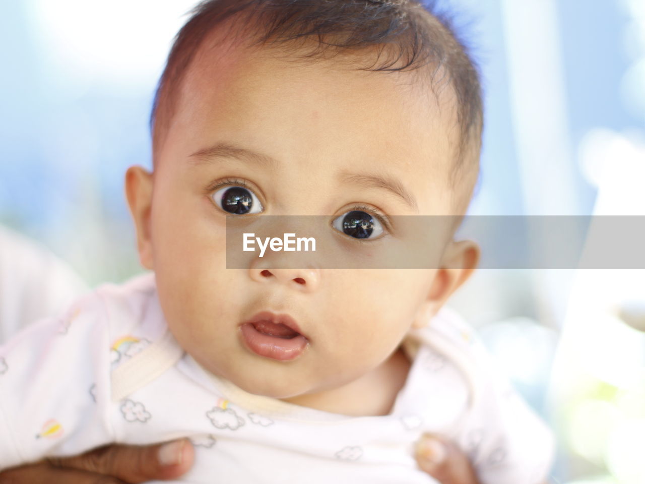 baby, child, childhood, portrait, person, cute, innocence, one person, looking at camera, emotion, baby clothing, indoors, beginnings, babyhood, headshot, clothing, toddler, skin, close-up, human face, looking, front view, facial expression, human mouth, lying down, happiness, portrait photography, positive emotion, brown eyes, nose, mouth open, lifestyles, care, nature, smiling, eye, focus on foreground