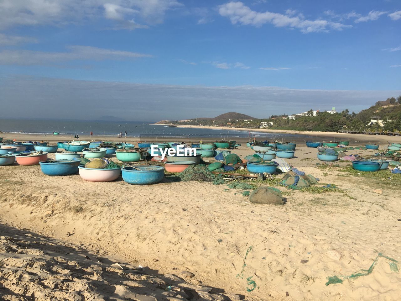 BOATS ON BEACH AGAINST SKY