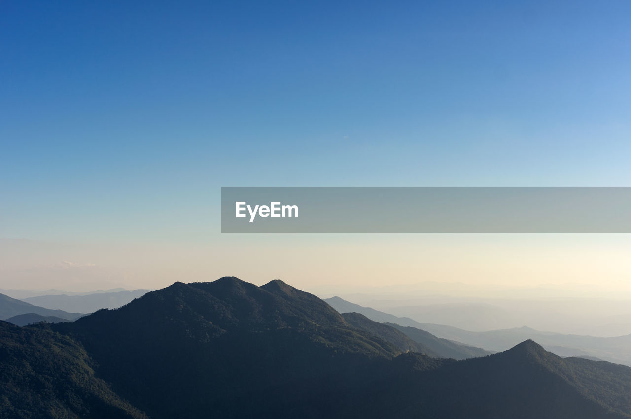 Scenic view of silhouette mountains against clear sky