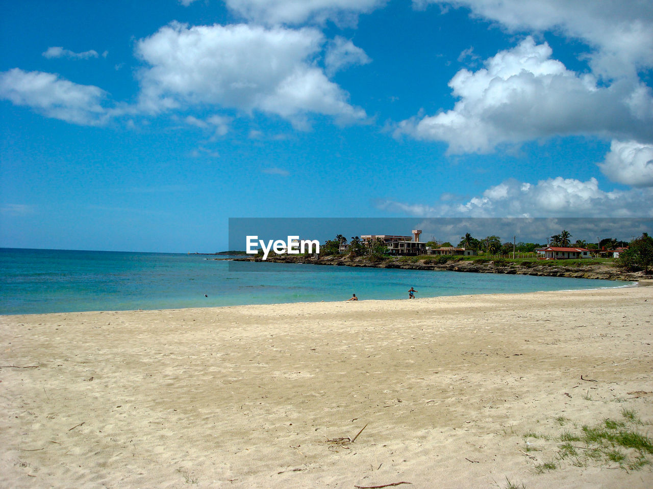 Scenic view of beach against blue sky