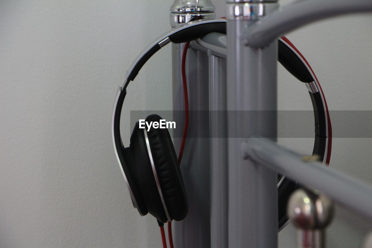 Close-up of headphones on railing