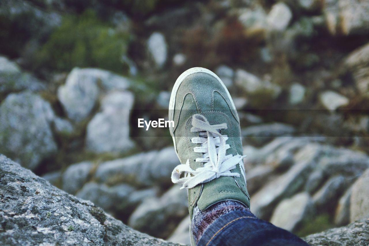 CLOSE-UP OF ROCKS AGAINST BLURRED BACKGROUND