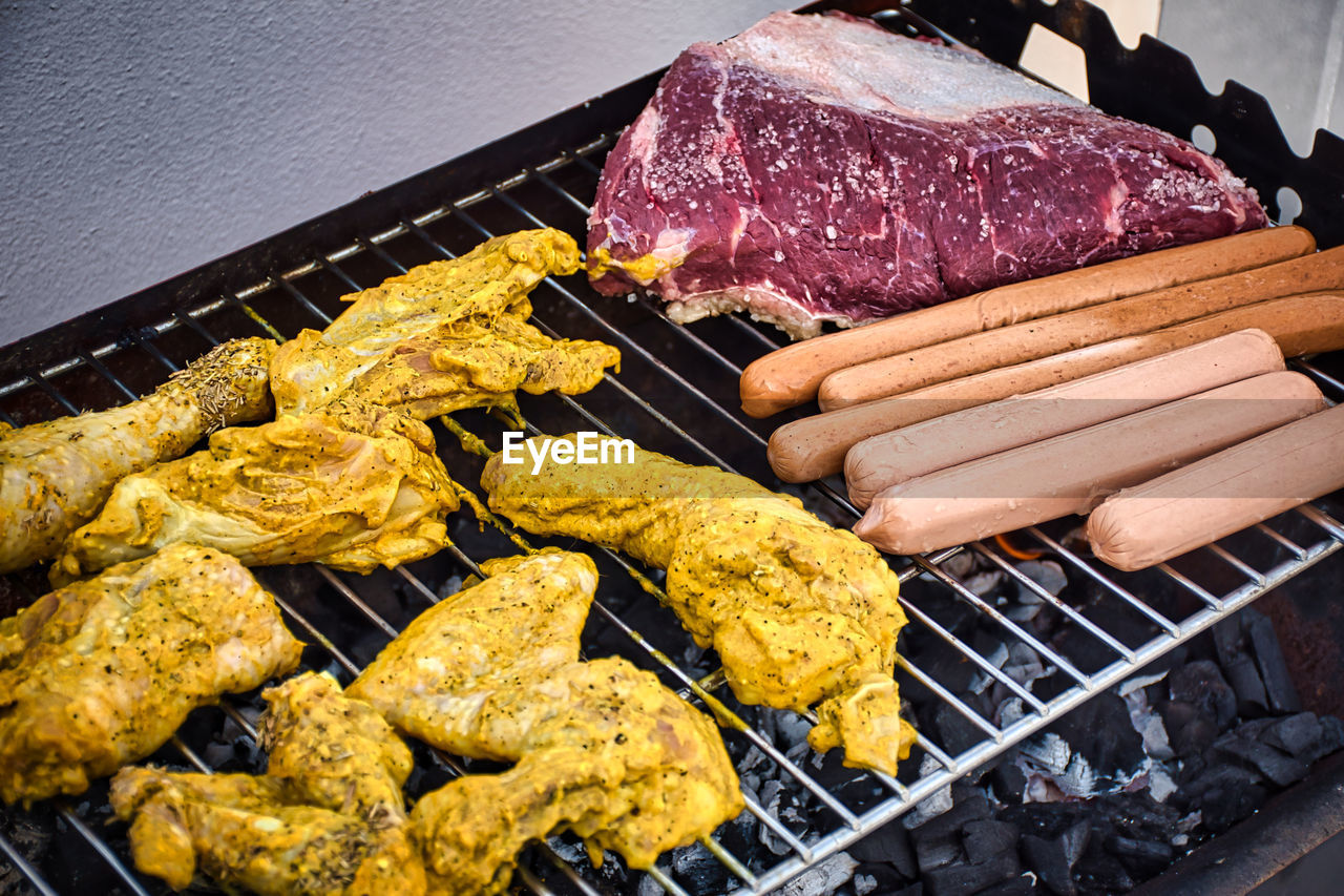 Assorted delicious to be grilled meat over the coals on barbecue