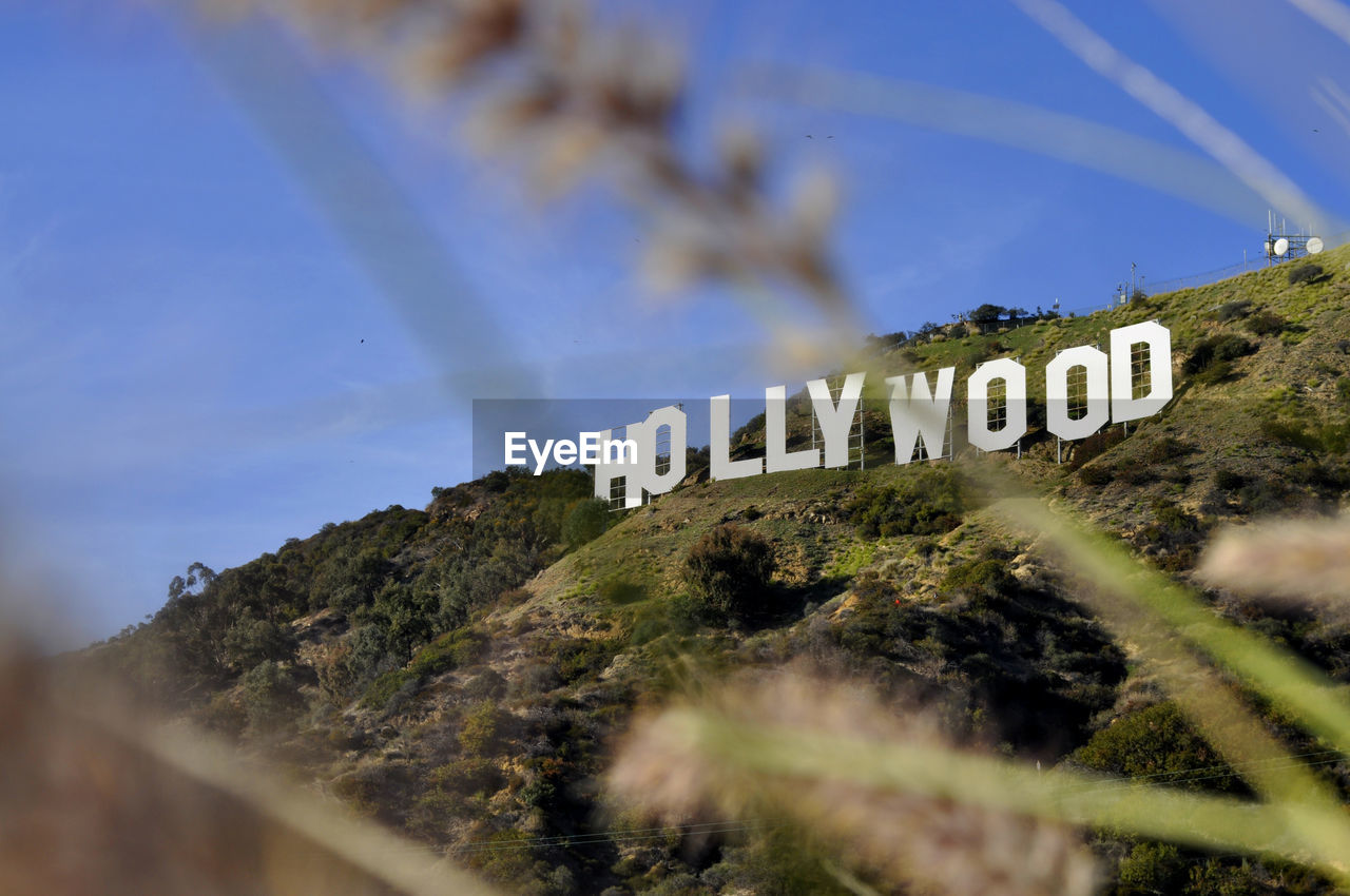 Low angle view of hollywood on mountains against sky