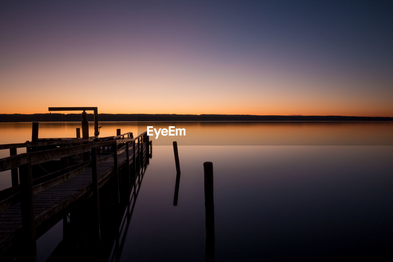 Scenic view of sea against clear sky during sunset