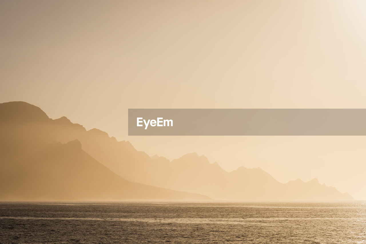 Scenic view of sea against clear sky during sunset