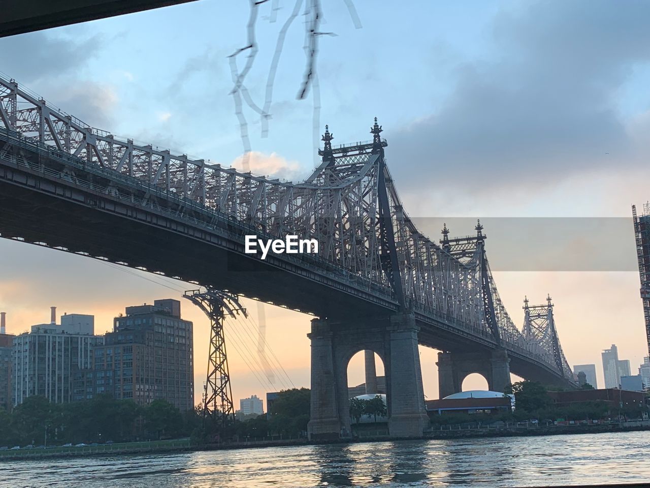 Bridge over river with city in background