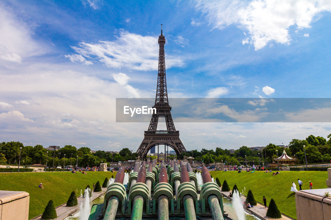 TOWER OF BUILDING AGAINST CLOUDY SKY IN CITY