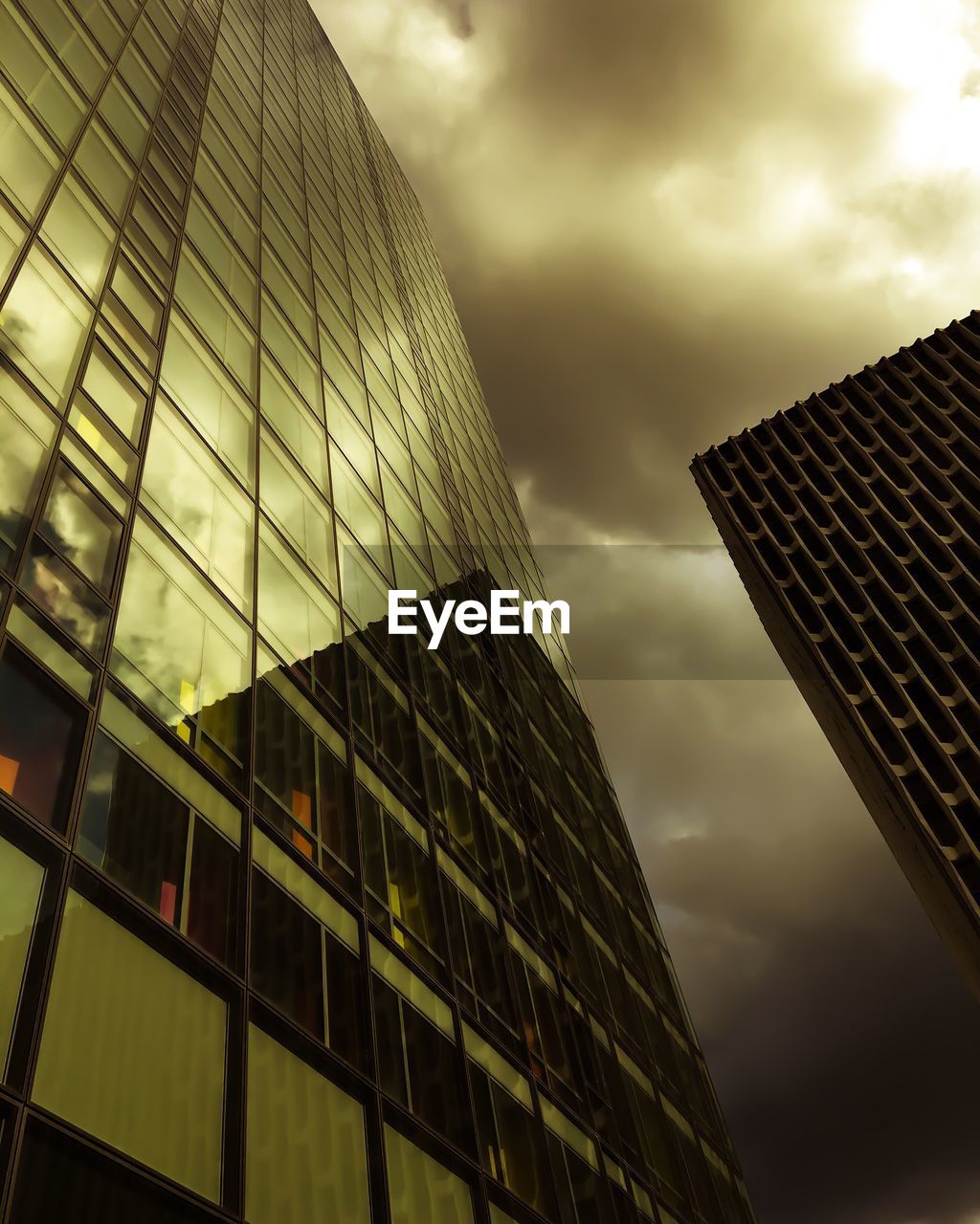 LOW ANGLE VIEW OF MODERN BUILDING AGAINST CLOUDY SKY