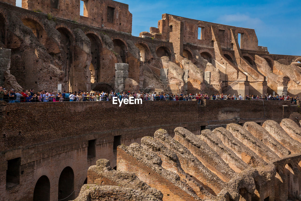 Tourists visiting the interior of the famous colosseum in rome