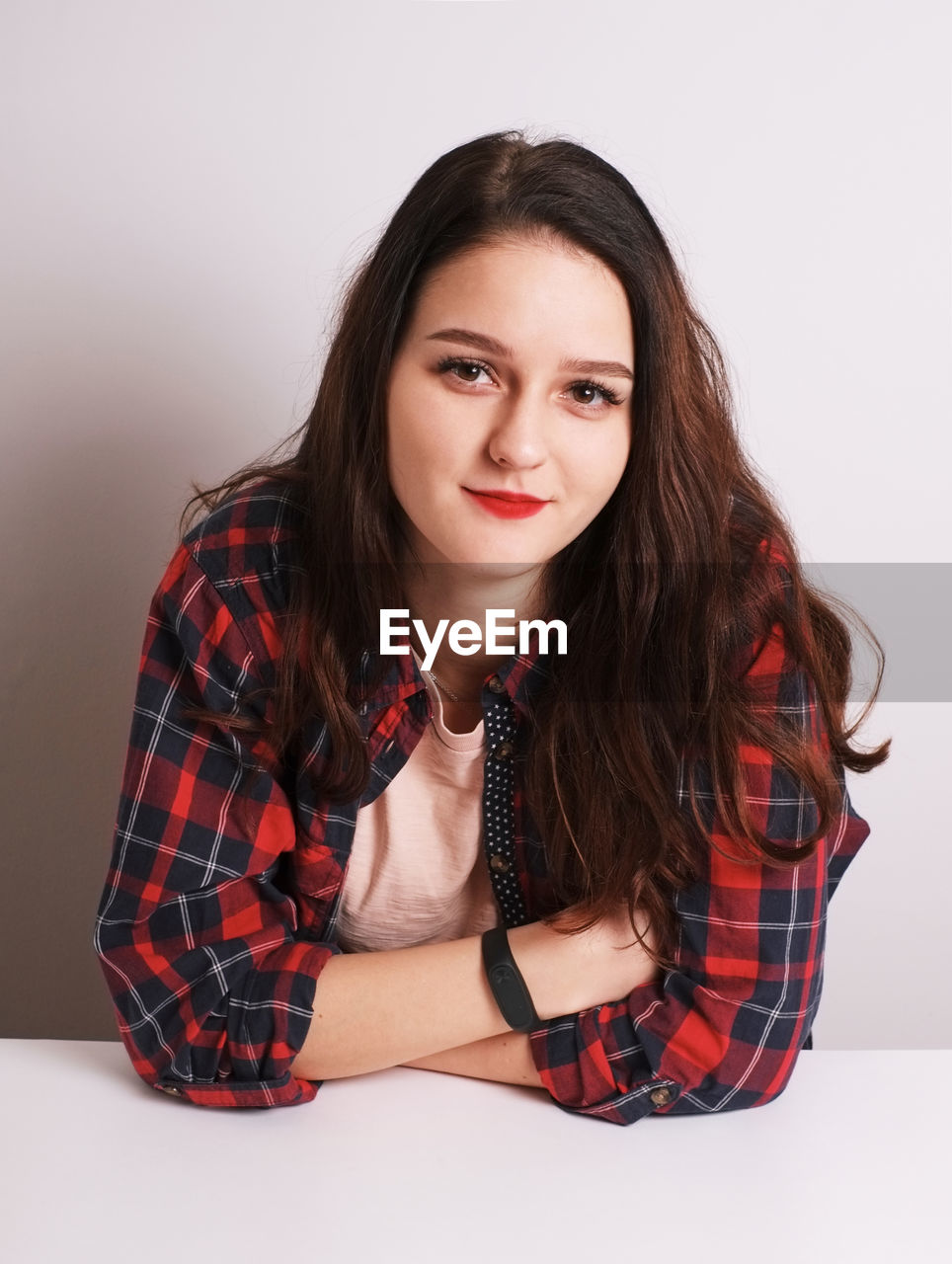 PORTRAIT OF A YOUNG WOMAN AGAINST WHITE BACKGROUND