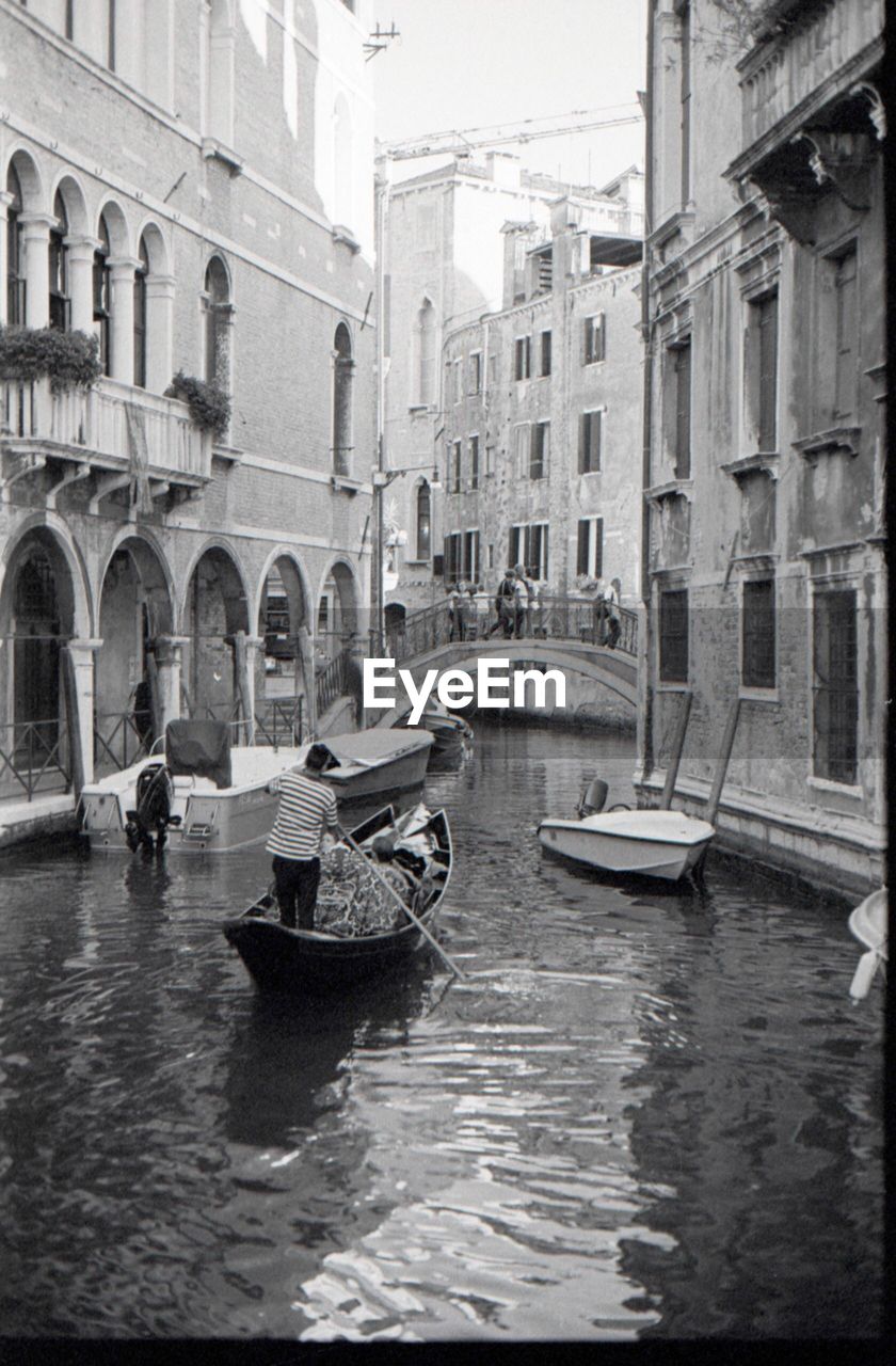 BOATS IN CANAL ALONG BUILDINGS