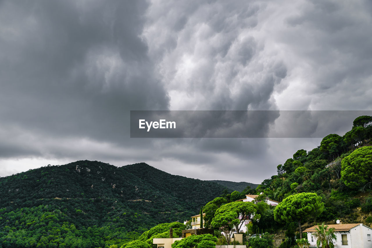 Scenic view of mountains against cloudy sky