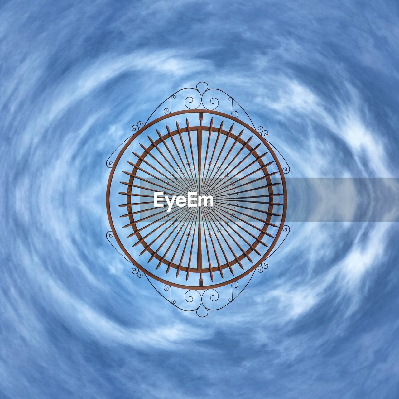 LOW ANGLE VIEW OF FERRIS WHEEL AGAINST CLOUDY SKY