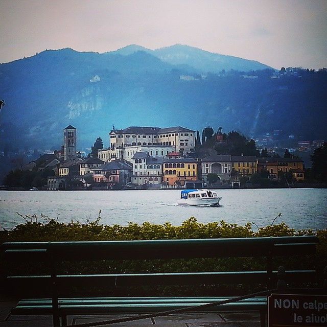 VIEW OF RIVER WITH MOUNTAINS IN BACKGROUND