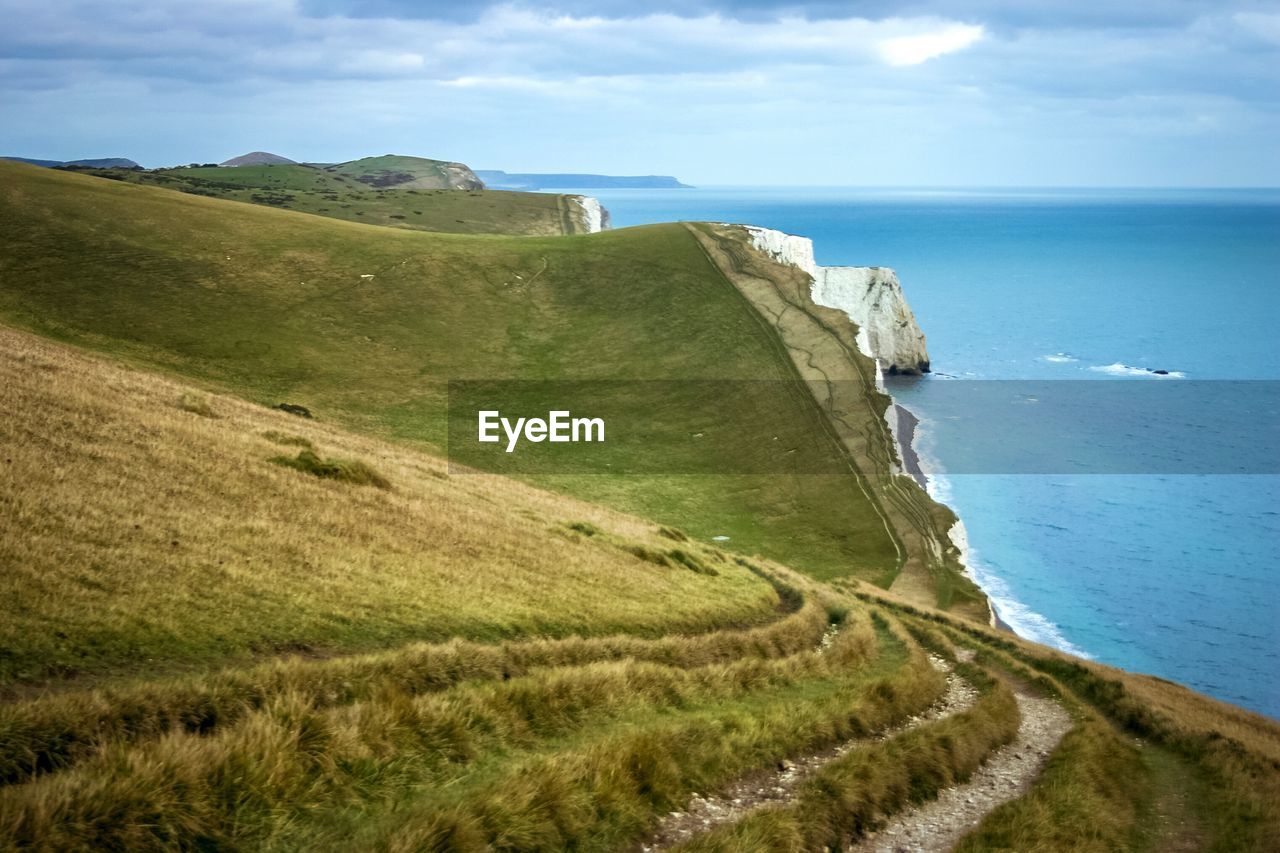 Scenic view of sea and mountains against sky
