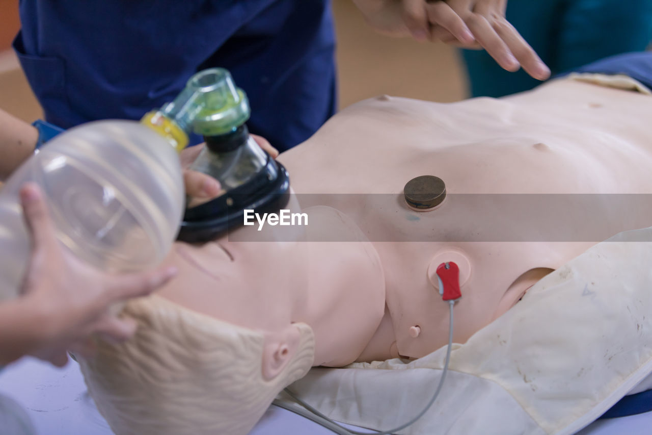 Cropped image of person learning cpr in hospital