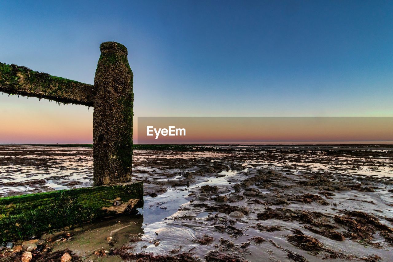 Scenic view of sea against clear sky during sunset