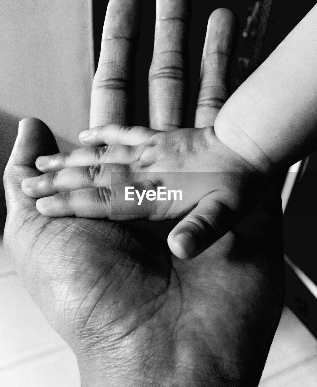 CLOSE-UP OF HANDS HOLDING BABY