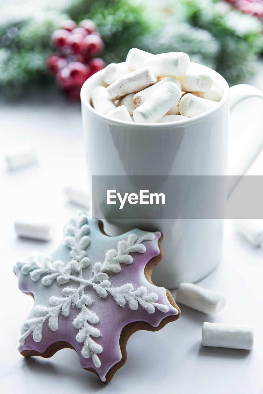 Christmas cocoa, gingerbread cookies and decorations. white wooden background.