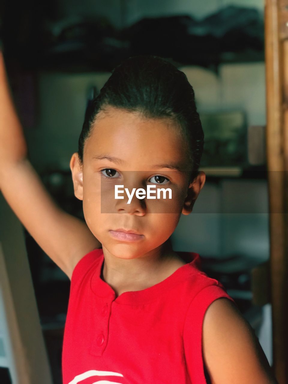 Portrait of serious girl standing at home