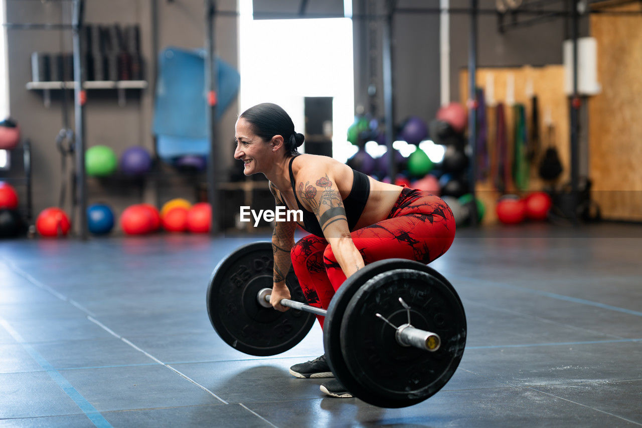 side view of man exercising in gym