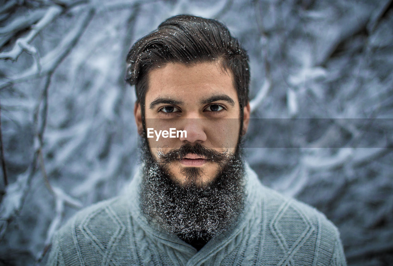 Portrait of young bearded man during winter